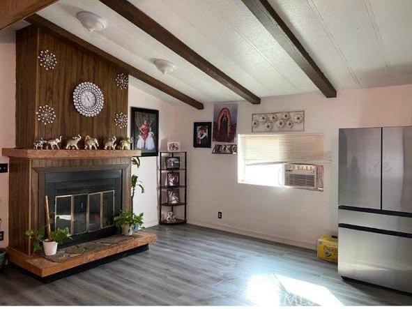 499 Pacheco Road, Unit 214 Bakersfield, CA 93307 - Photo 2 of 8 a kitchen with furniture and a fireplace