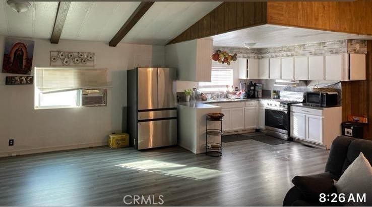 499 Pacheco Road, Unit 214 Bakersfield, CA 93307 - Photo 4 of 8 a kitchen with stainless steel appliances a refrigerator a stove a sink dishwasher a refrigerator with wooden floor