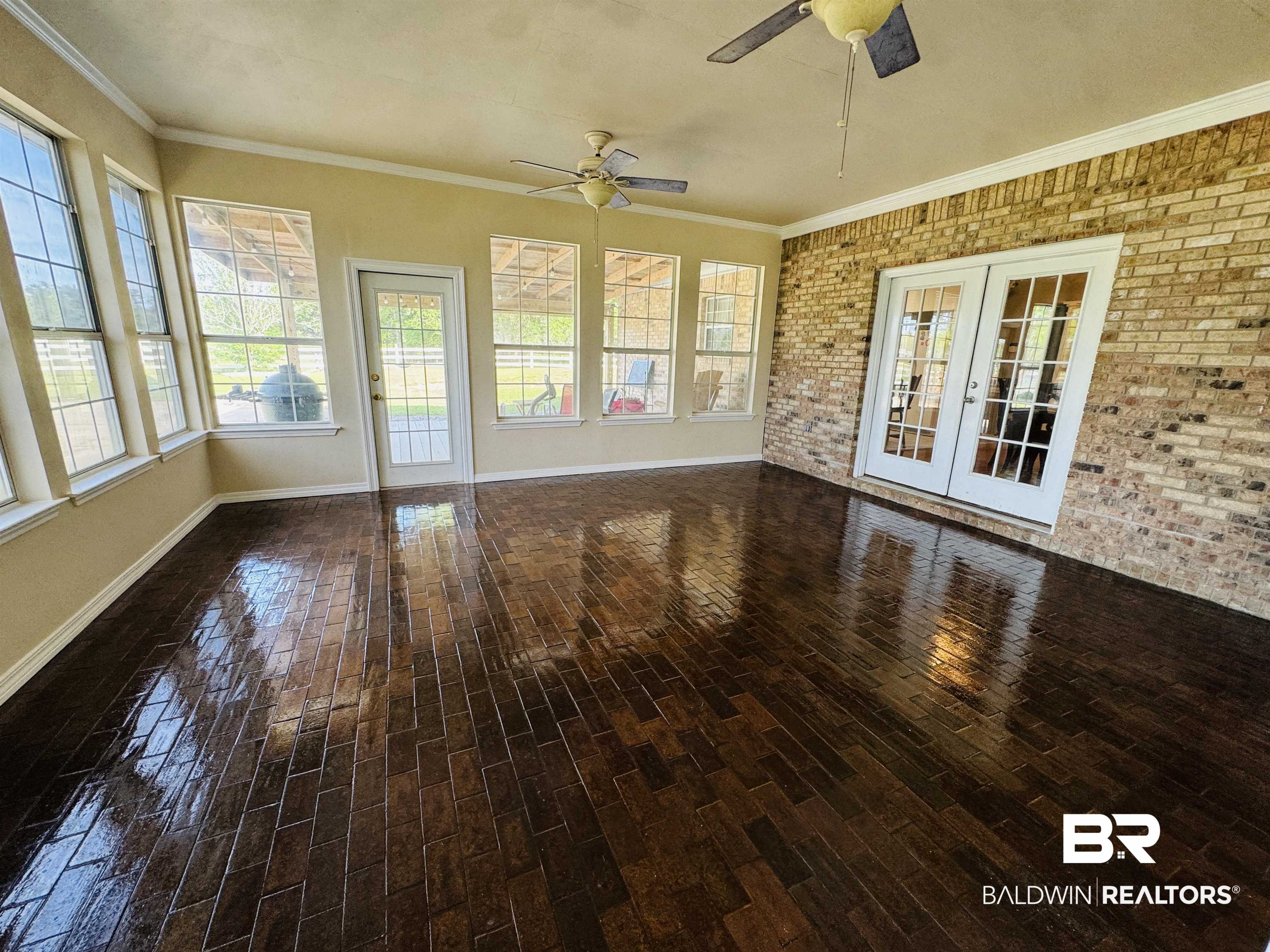 13795 White Road Silverhill, AL 36576 - Photo 42 of 99 Unfurnished sunroom with french doors, brick wall, crown molding, wood finished floors, and a ceiling fan