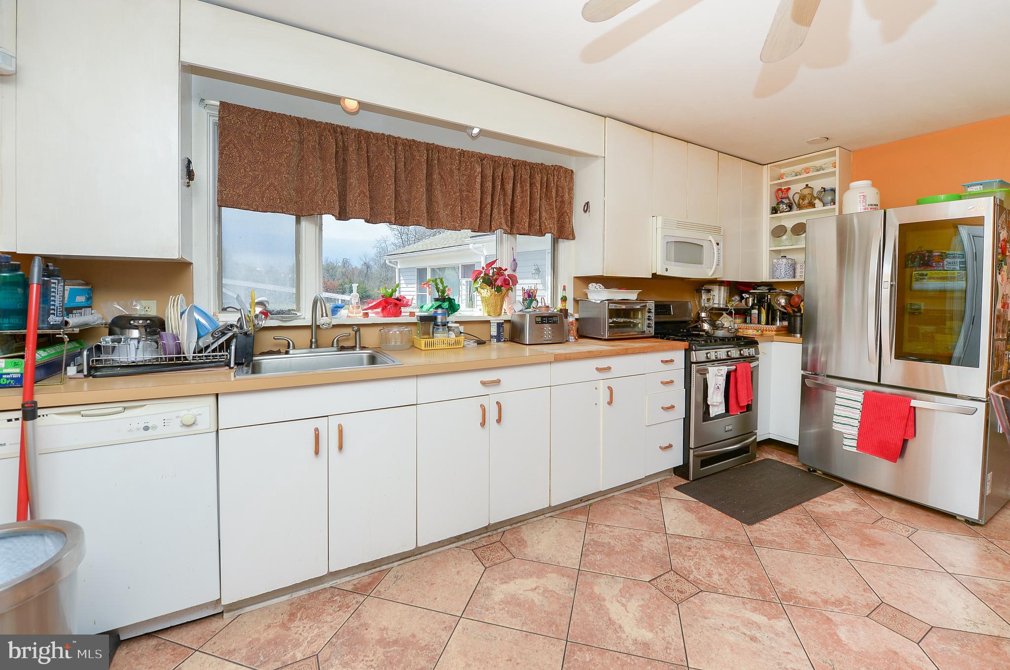 922 Route 601 Skillman Nj 08558 Skillman, NJ 08558 - Photo 13 of 59 a kitchen with stainless steel appliances a sink and cabinets
