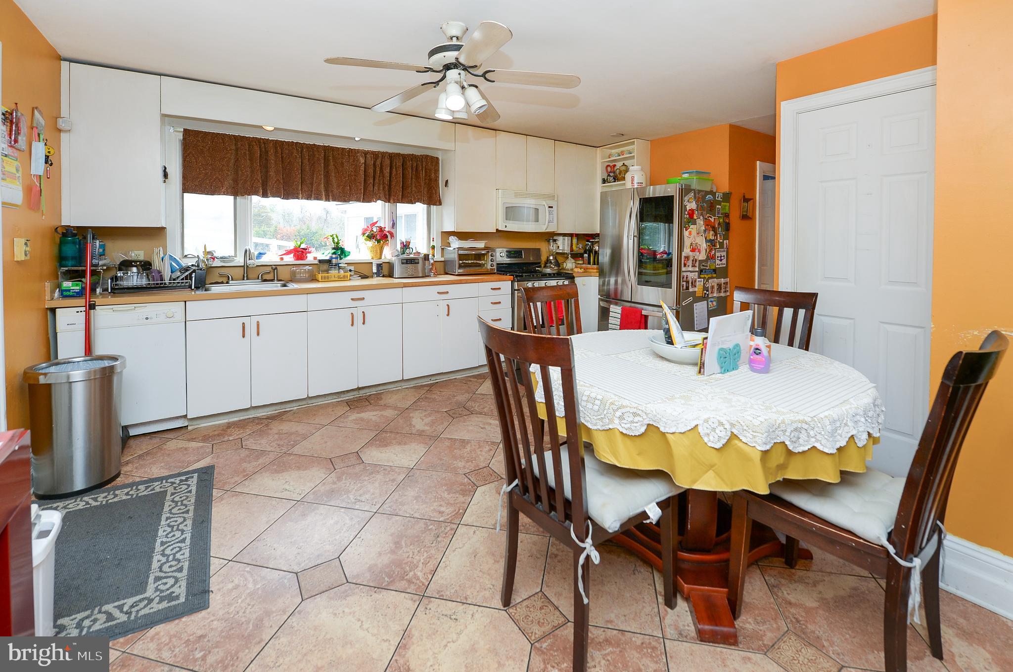 922 Route 601 Skillman Nj 08558 Skillman, NJ 08558 - Photo 14 of 59 a kitchen with stainless steel appliances kitchen island granite countertop a table chairs and a refrigerator