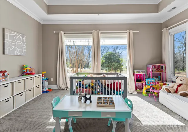 a view of a dining room with furniture window and a kitchen view