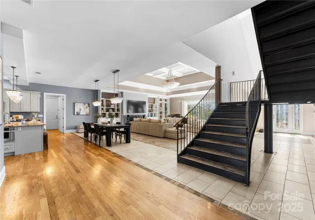 a living room with furniture and a dining table with kitchen view