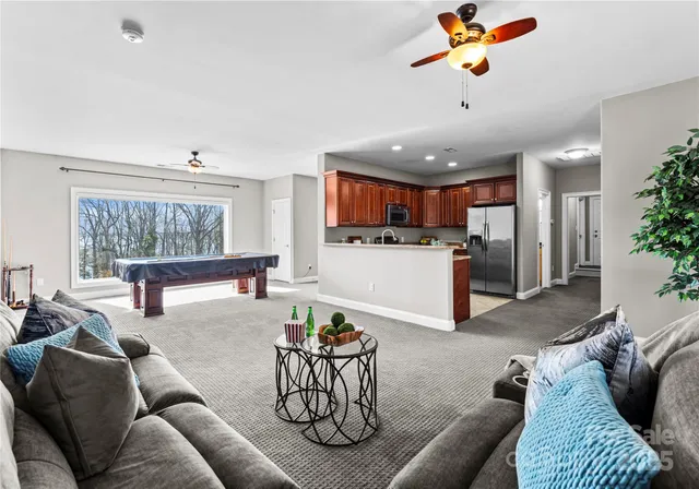 a living room with furniture and kitchen view