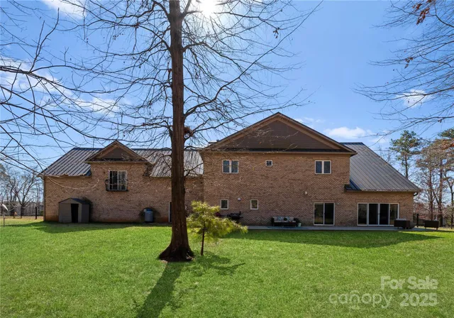 a front view of a house with a garden and plants