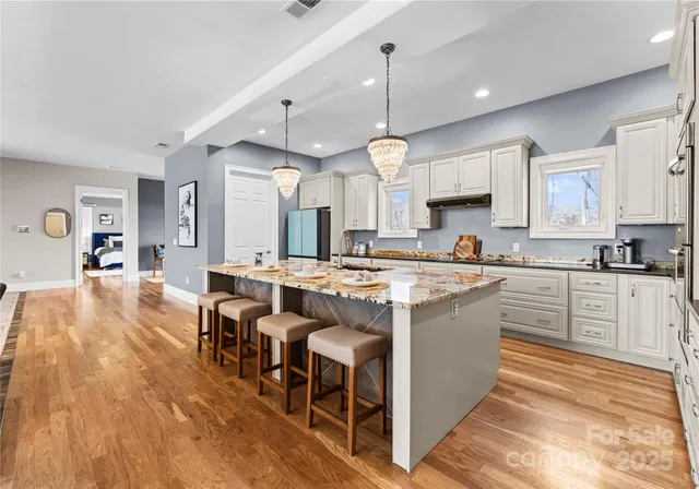 a large kitchen with lots of counter space and dining table