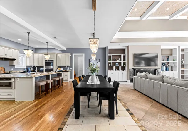 a living room with stainless steel appliances kitchen island granite countertop furniture and a kitchen view