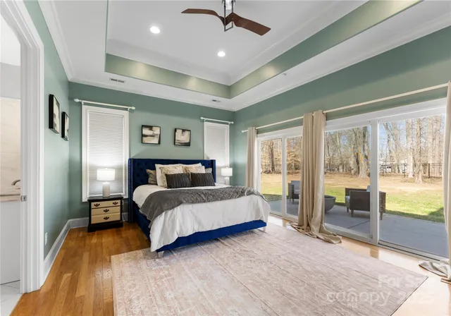 a spacious bedroom with a large bed and a large window