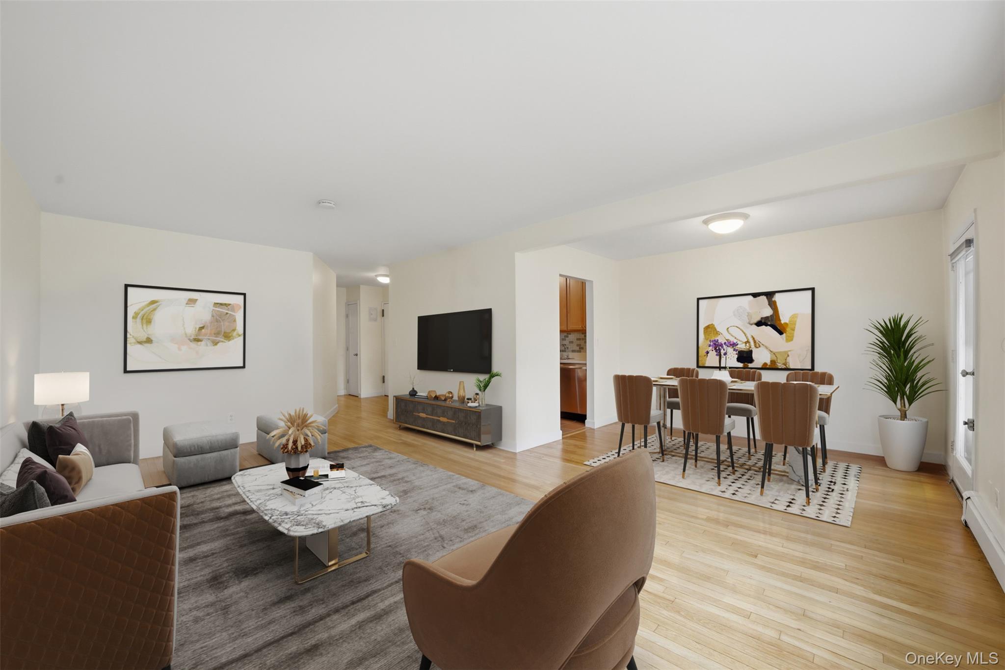a living room with furniture a wooden floor and a flat screen tv