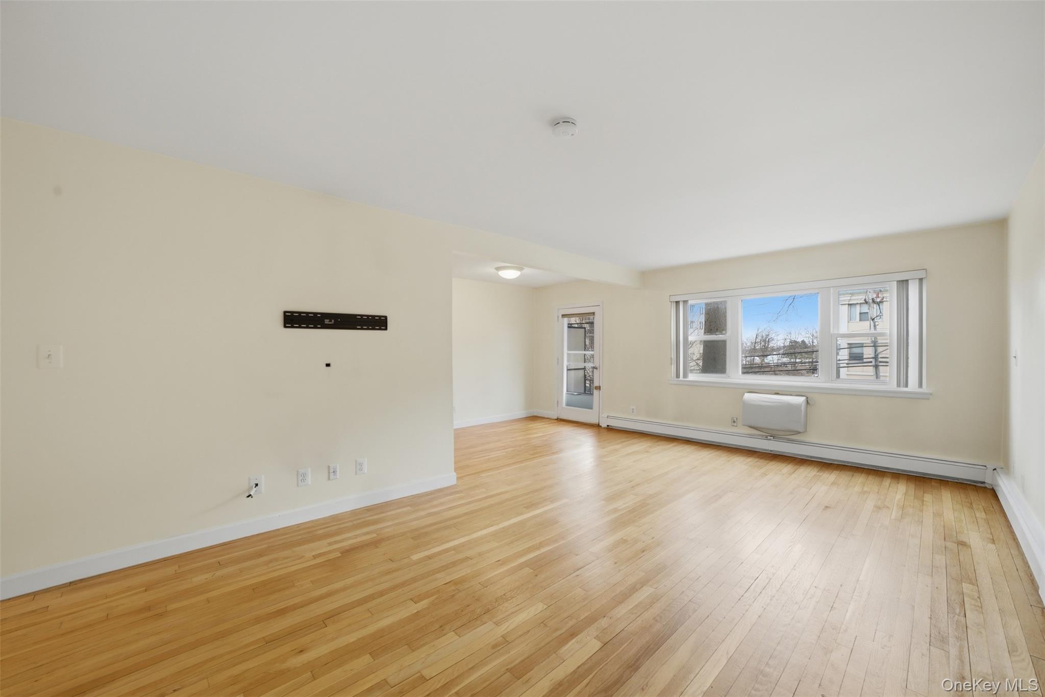 667 Pelham Road, Unit B10 New Rochelle, NY 10805 - Photo 4 of 16 a view of a room with wooden floor and window