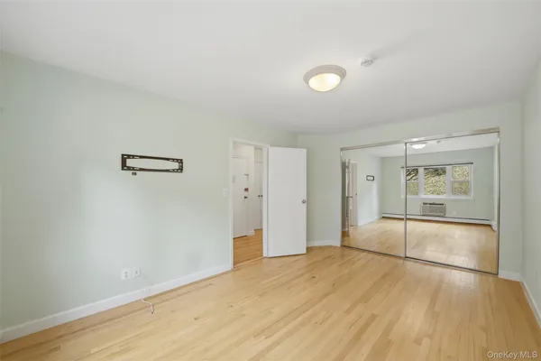 an empty room with wooden floor and sliding door