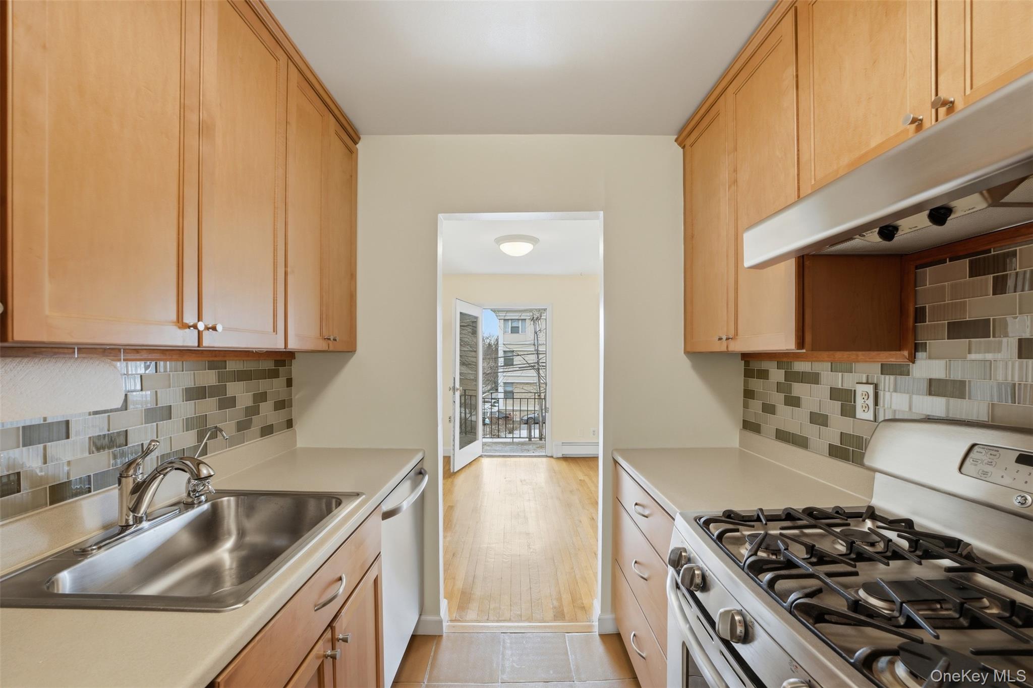 667 Pelham Road, Unit B10 New Rochelle, NY 10805 - Photo 10 of 16 a kitchen with stainless steel appliances granite countertop a sink stove and cabinets