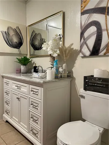 a bathroom with a toilet a sink and a mirror
