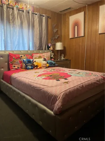 a bedroom with a bed and a table