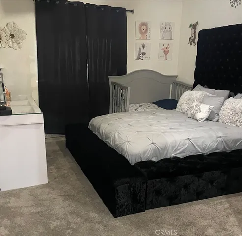 a bedroom with a bed and a cabinets