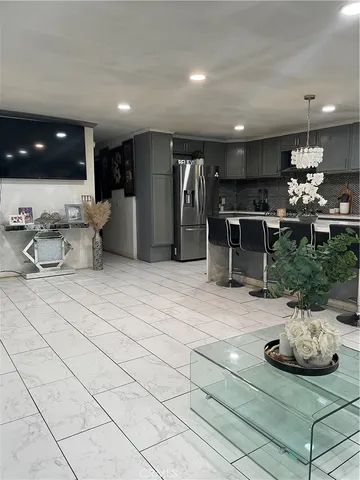 a kitchen with stainless steel appliances kitchen island granite countertop a sink and a cabinets