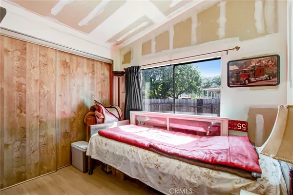 a bedroom with a bed and a large window