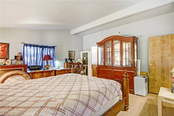 a bedroom with a bed and a large windows
