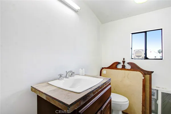 a bathroom with a sink toilet and mirror