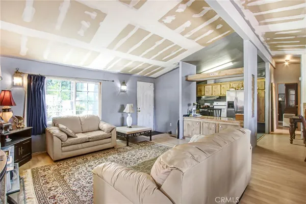 a living room with furniture wooden floor and a large window
