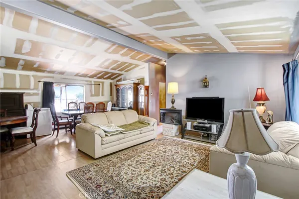 a living room with furniture a rug and a flat screen tv