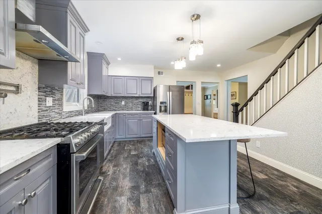 a kitchen with a stove and a kitchen island