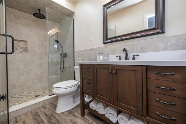 a bathroom with a sink toilet and shower