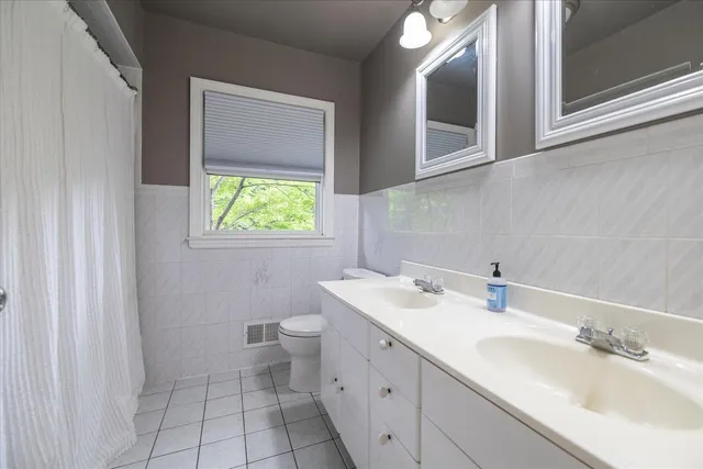 a bathroom with a sink toilet and mirror