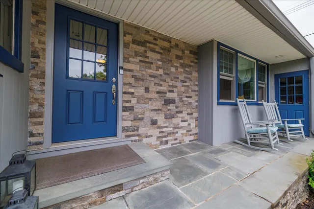 a front view of a house with outdoor seating