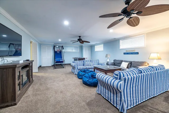 a living room with lots of furniture and chandelier