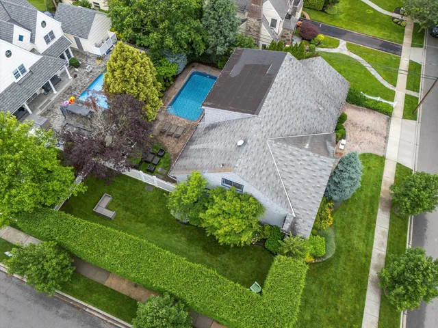 an aerial view of a house with a garden and trees