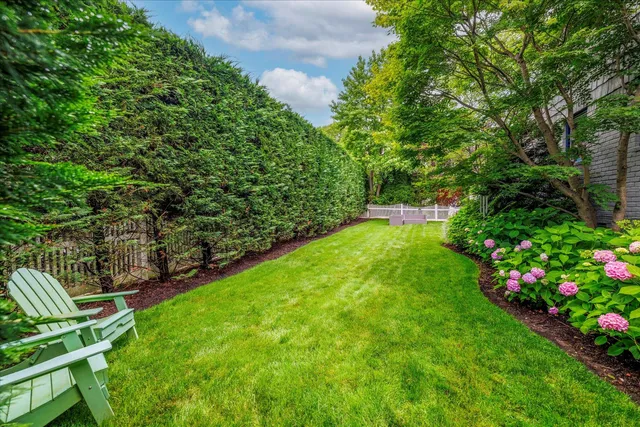 a view of yard with seating area and garden