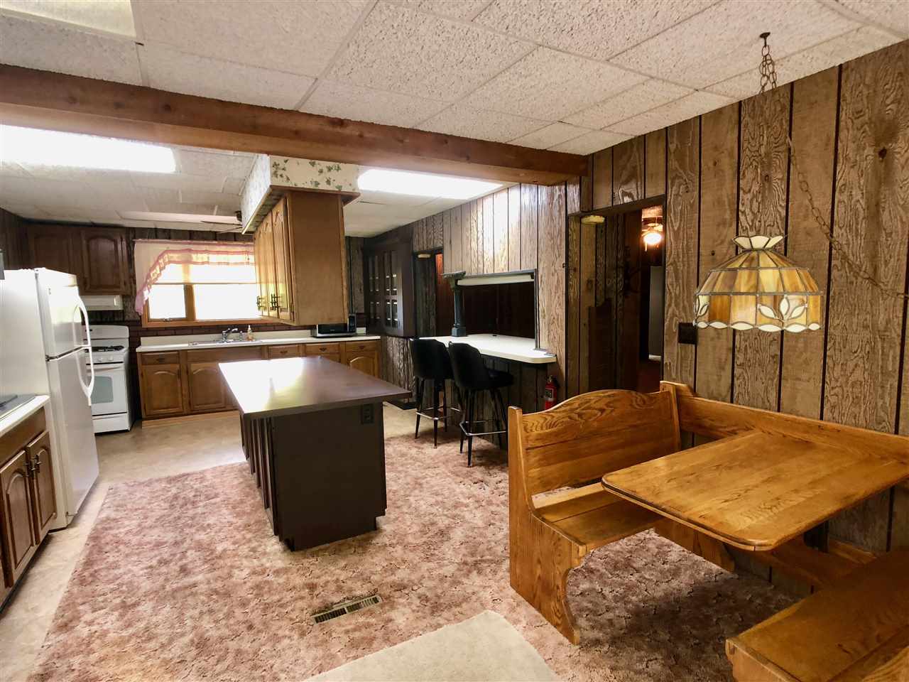 6038 Tipple Road Rockford, IL 61102 - Photo 7 of 25 a living room with couches and kitchen view with wooden floor