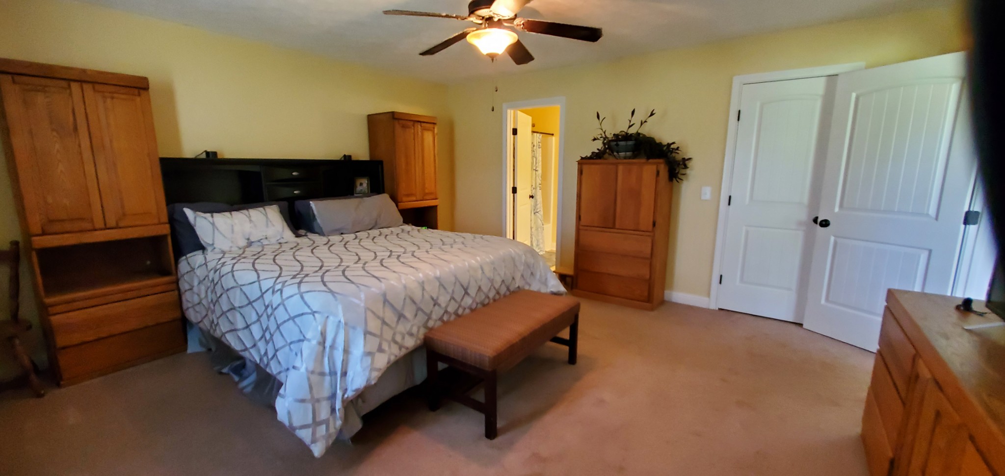 140 T G T Road Portland, TN 37148 - Photo 8 of 13 a spacious bedroom with a bed and a chandelier