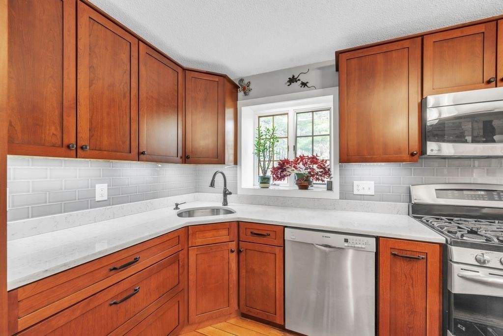 1 St Germain Road Hampden, MA 01036 - Photo 15 of 42 a kitchen with stainless steel appliances granite countertop wooden cabinets a sink and dishwasher
