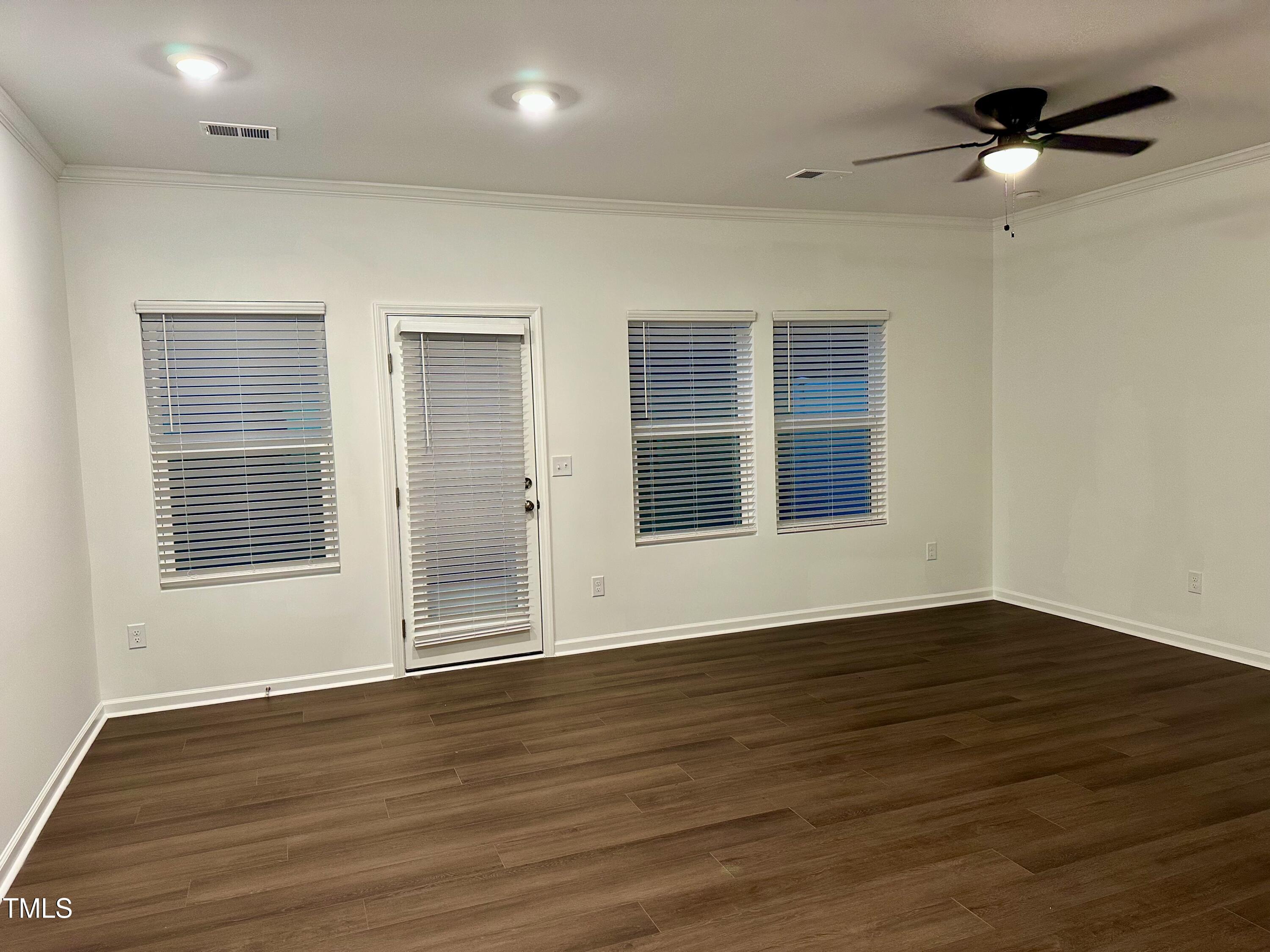 3008 Vitner Drive Durham, NC 27704 - Photo 2 of 17 an empty room with wooden floor and windows