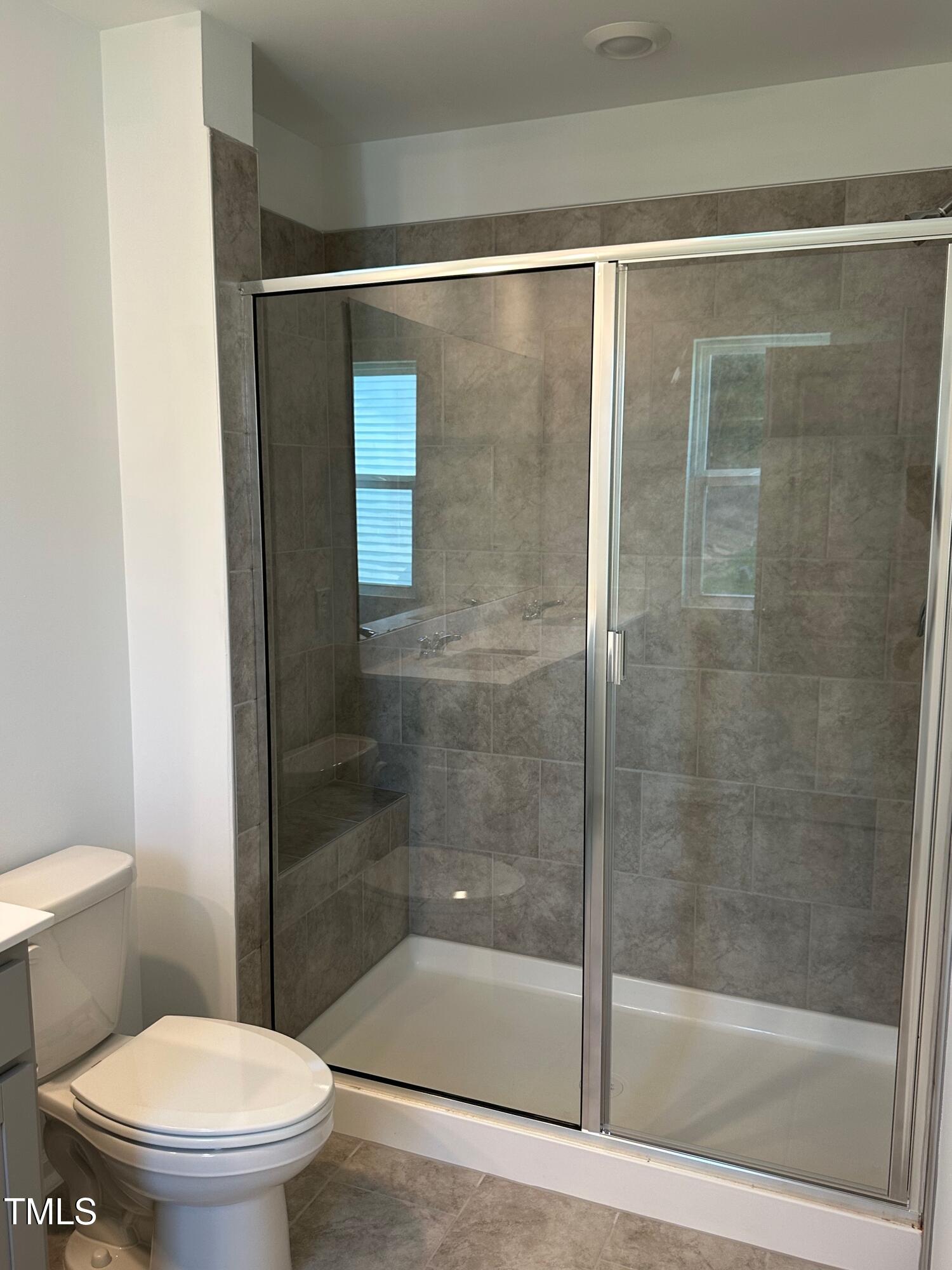 3008 Vitner Drive Durham, NC 27704 - Photo 6 of 17 a bathroom with a shower a toilet and a sink