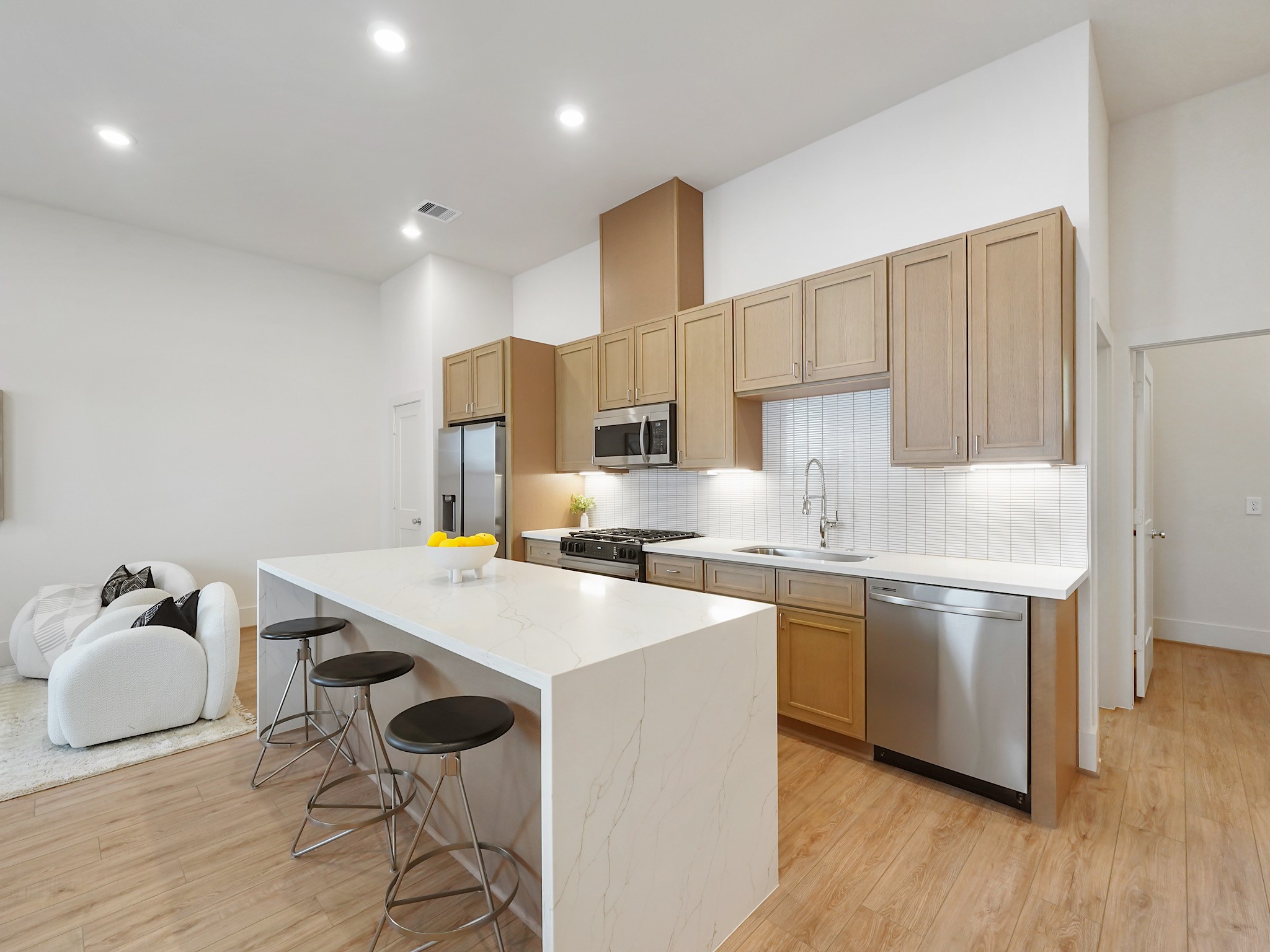 861 Rachel Street, Unit E Houston, TX 77091 - Photo 6 of 29 This modern kitchen features sleek stainless steel appliances and a spacious breakfast bar, creating an ideal setting for entertaining guests.