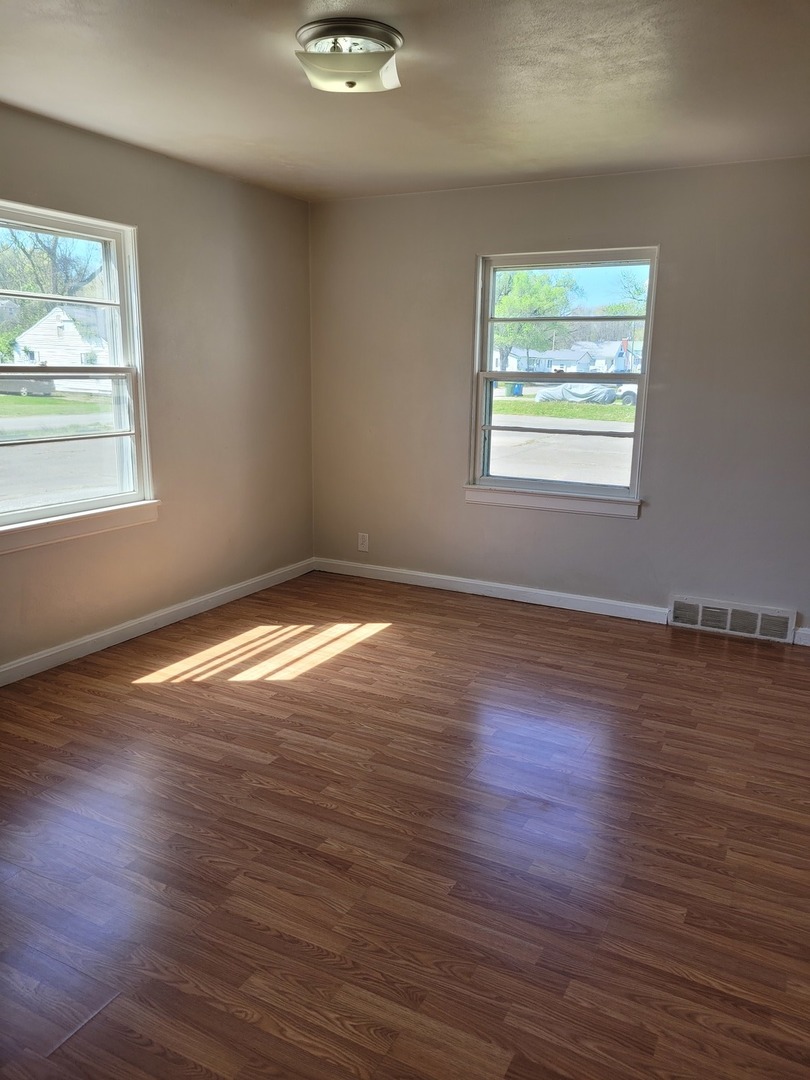 507 North 12th Street Mount Vernon, IL 62864 - Photo 14 of 23 an empty room with wooden floor and windows