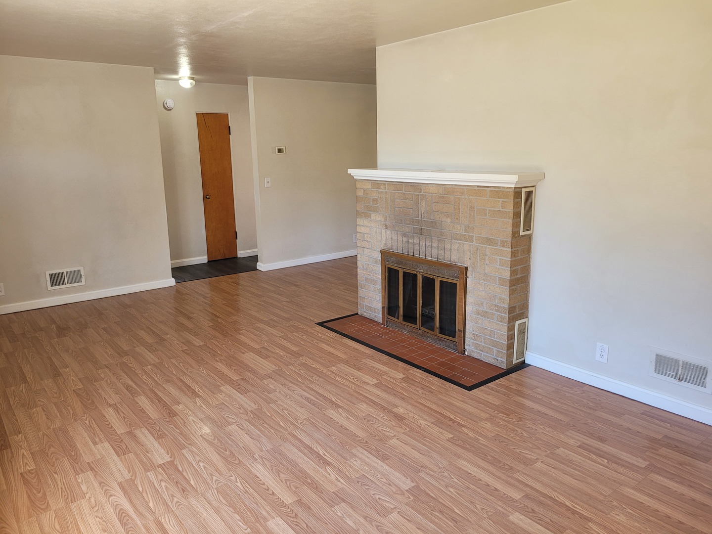 507 North 12th Street Mount Vernon, IL 62864 - Photo 8 of 23 a view of an empty room with wooden floor and a fireplace