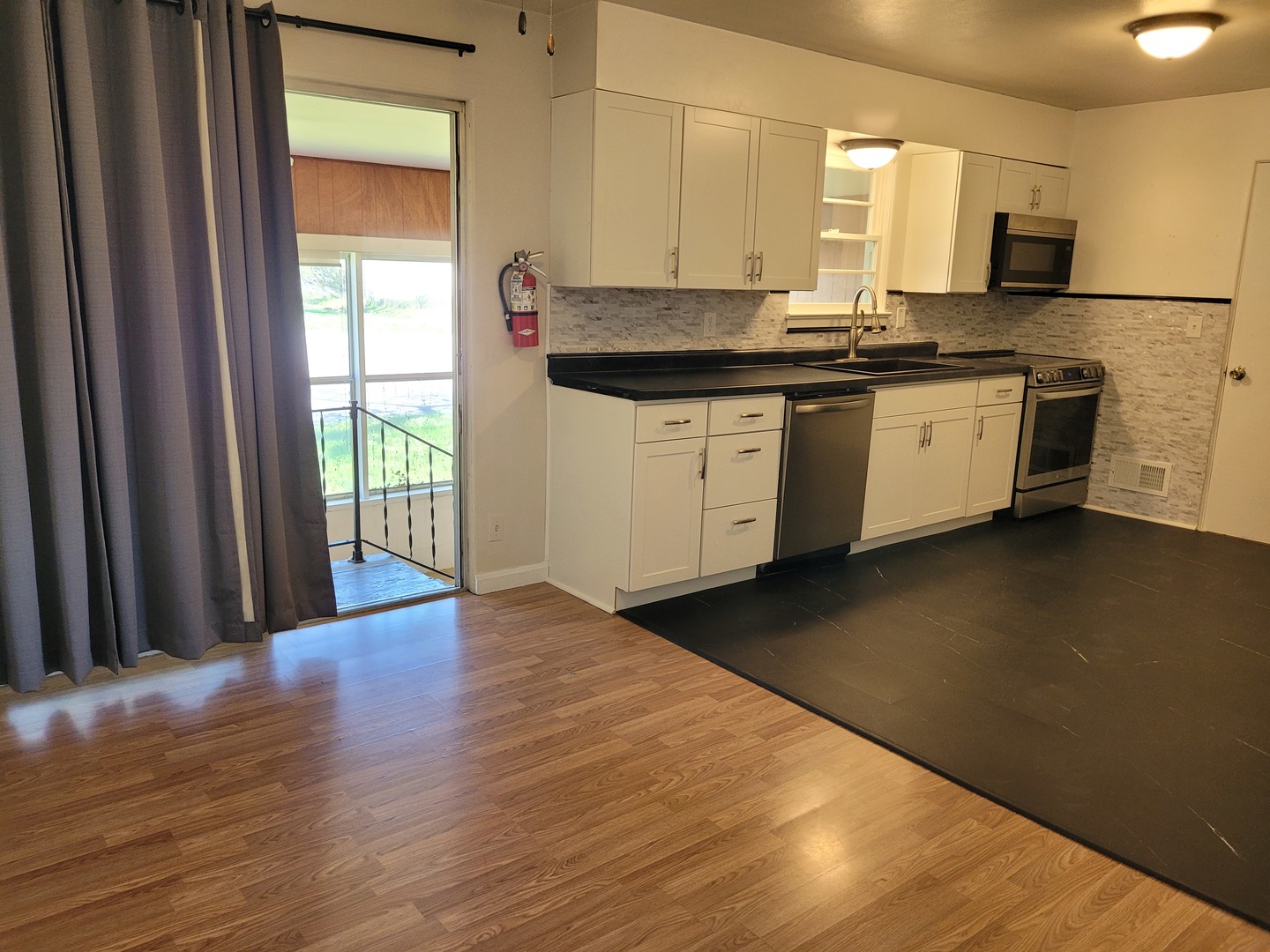 507 North 12th Street Mount Vernon, IL 62864 - Photo 9 of 23 a kitchen with stainless steel appliances granite countertop a sink a stove top oven a counter space and cabinets