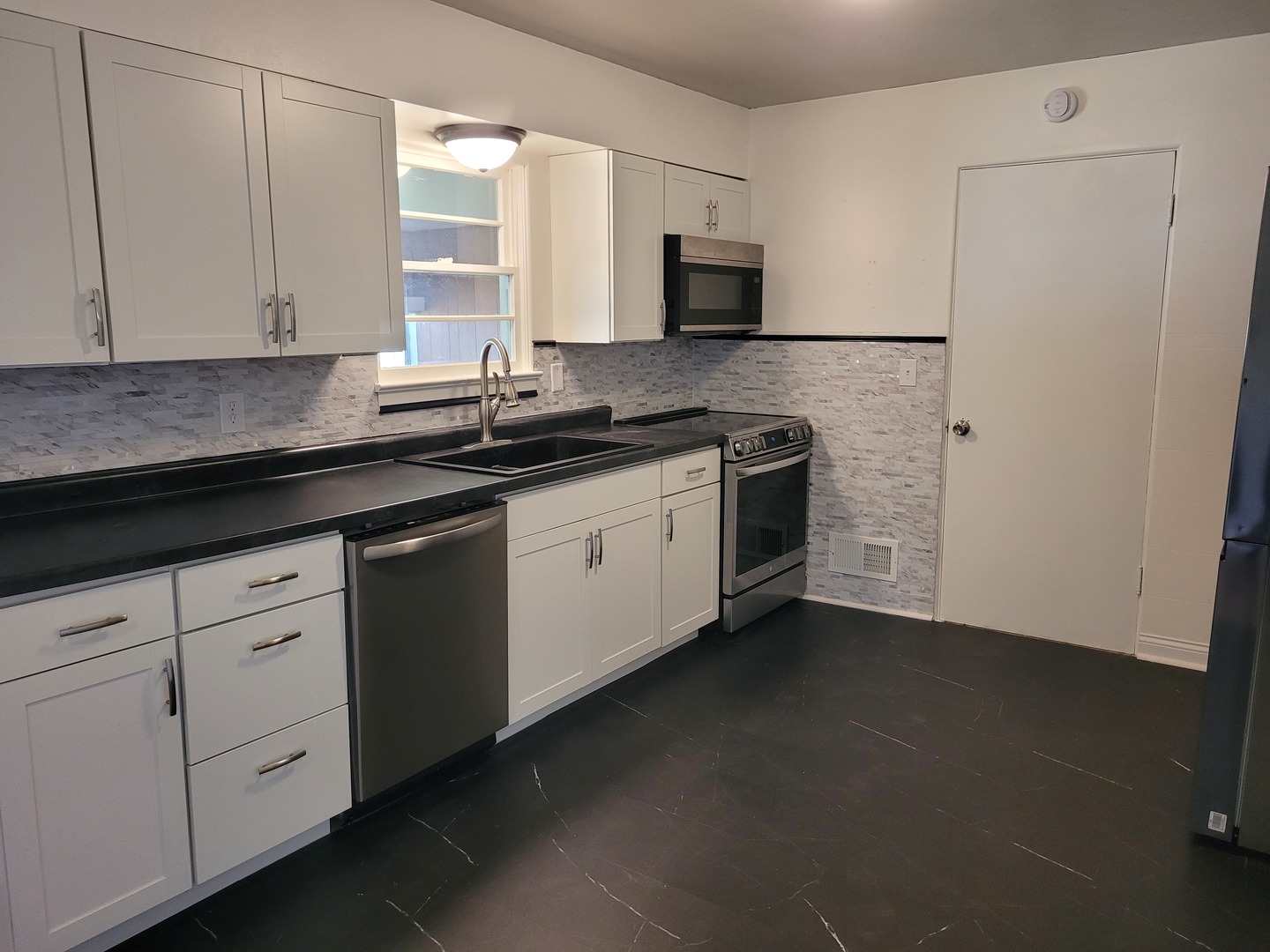507 North 12th Street Mount Vernon, IL 62864 - Photo 10 of 23 a kitchen with stainless steel appliances granite countertop white cabinets a sink a stove a refrigerator and dishwasher