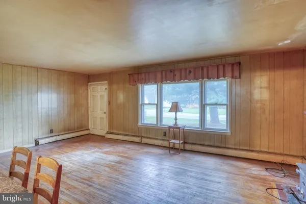 an empty room with furniture fireplace and wooden floor