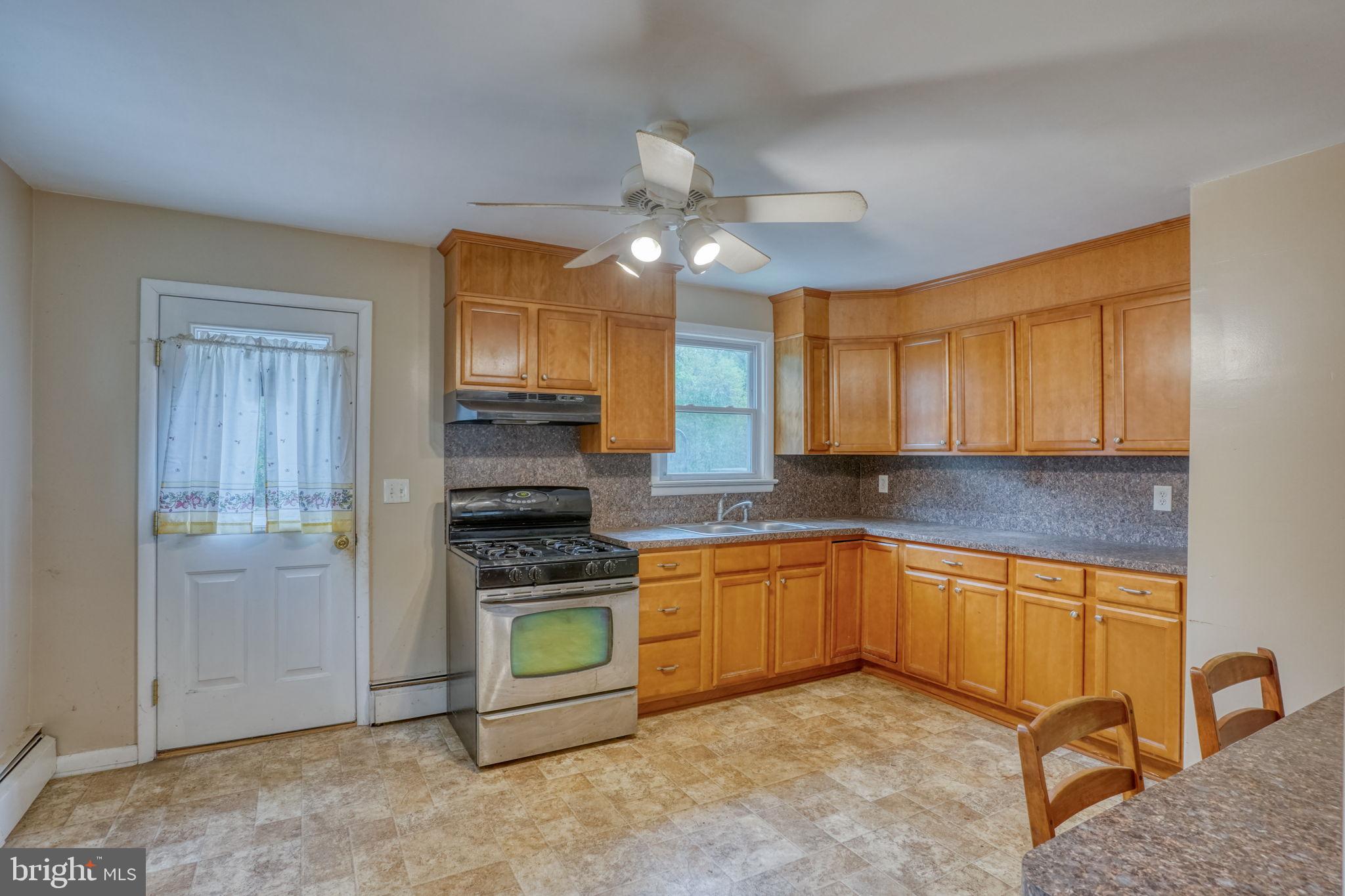 2927 Frazer Road Newark, DE 19702 - Photo 23 of 43 a kitchen with stainless steel appliances granite countertop a stove a sink and a refrigerator