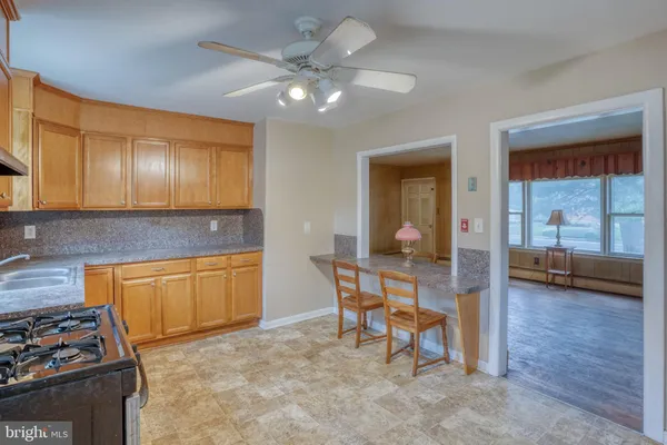 a kitchen with cabinets appliances and a window