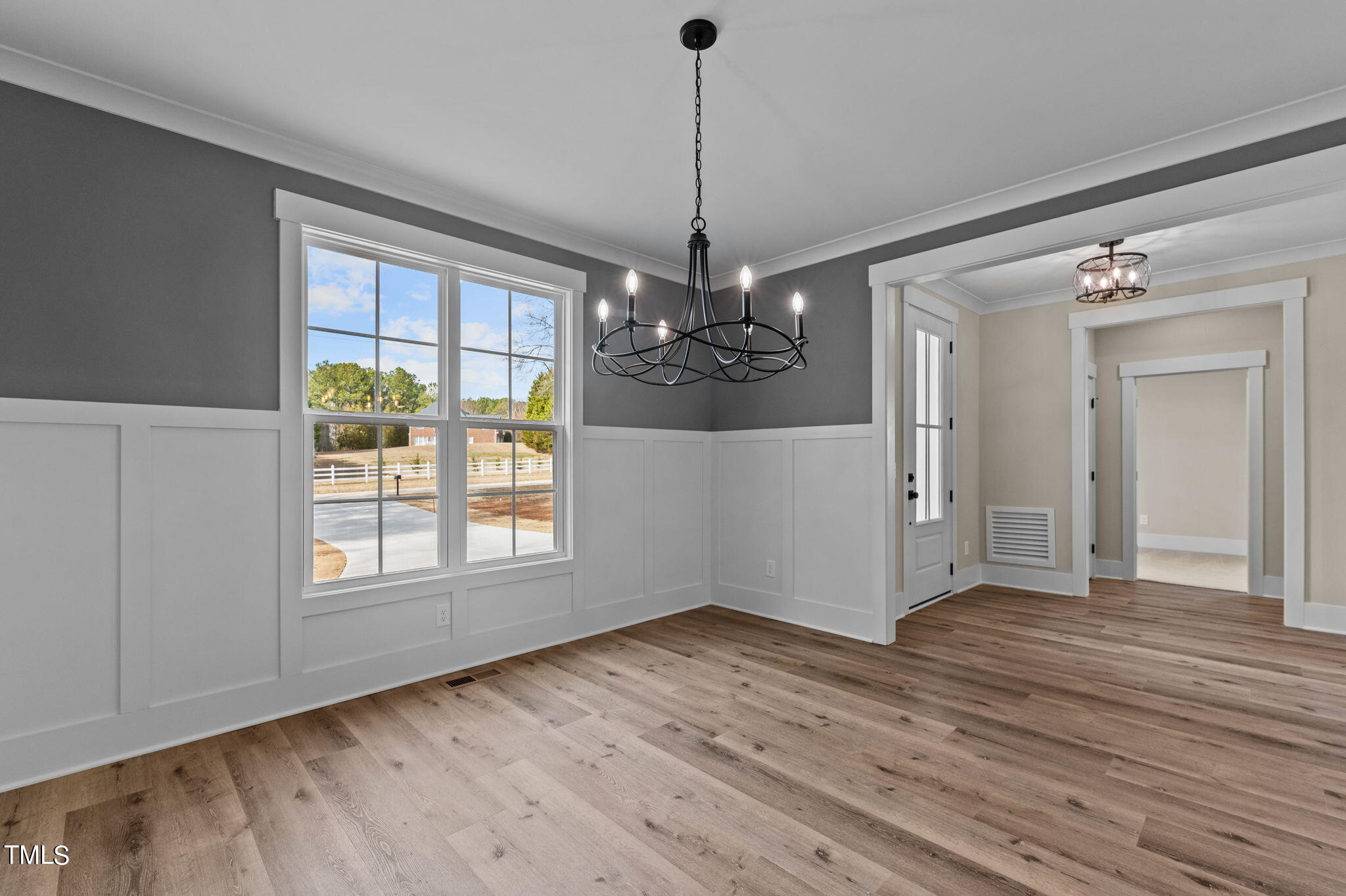 3816 Old Milburnie Road Raleigh, NC 27616 - Photo 12 of 58 a view of an empty room with wooden floor fridge and a window