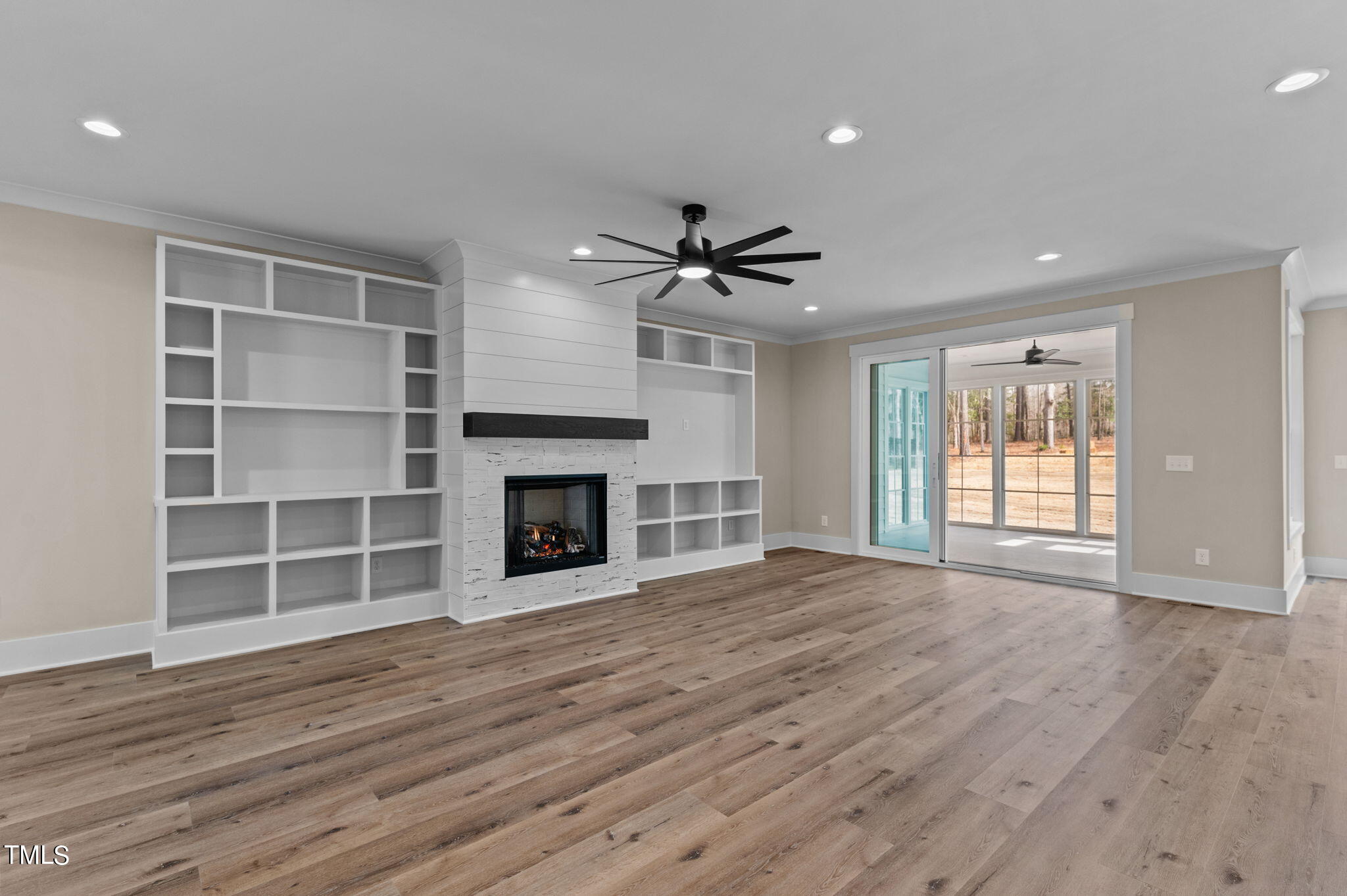 3816 Old Milburnie Road Raleigh, NC 27616 - Photo 13 of 58 a view of an empty room with a fireplace and a window