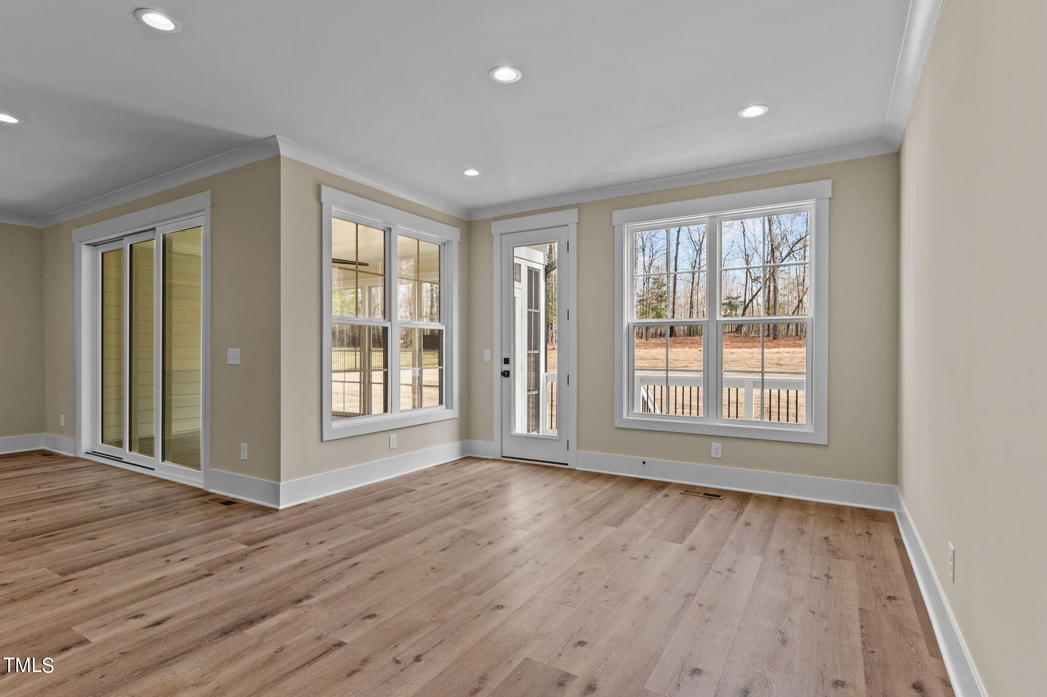 3816 Old Milburnie Road Raleigh, NC 27616 - Photo 16 of 58 a view of an empty room with wooden floor and a window
