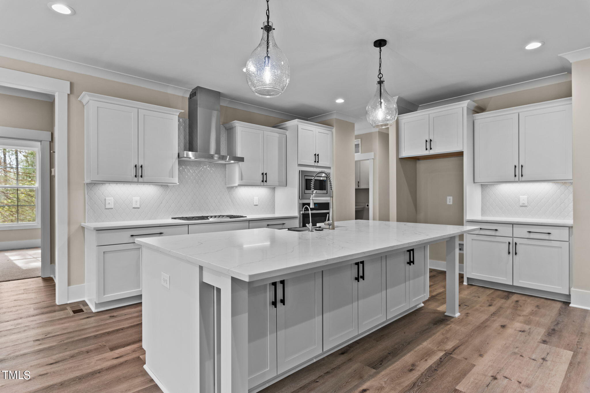 3816 Old Milburnie Road Raleigh, NC 27616 - Photo 25 of 58 a kitchen with kitchen island granite countertop a sink appliances cabinets and a counter top space