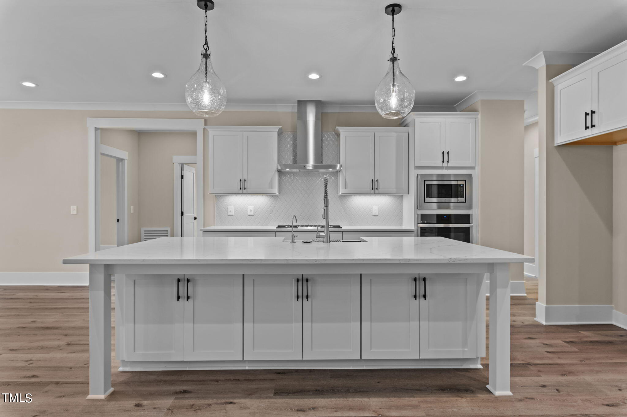 3816 Old Milburnie Road Raleigh, NC 27616 - Photo 26 of 58 a kitchen with kitchen island granite countertop a sink a center island and cabinets